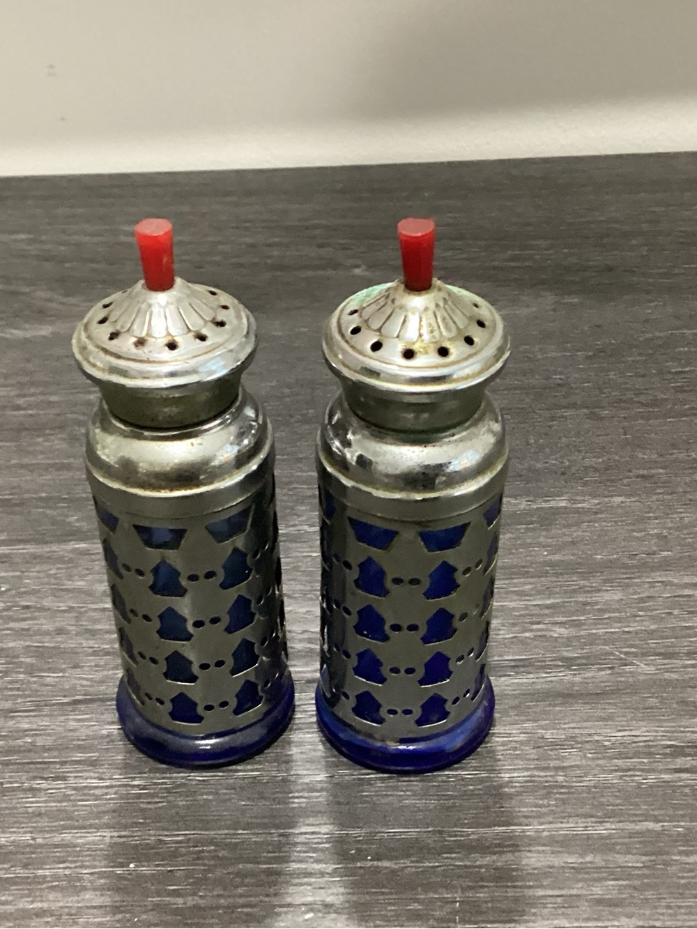 Antique Cobalt blue salt and pepper shakers encased in silver plated material